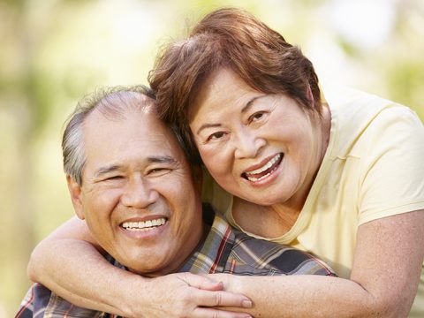 Older couple wearing affordable dentures