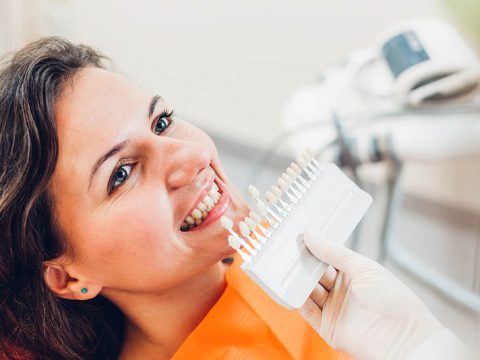 woman color matching for tooth bonding